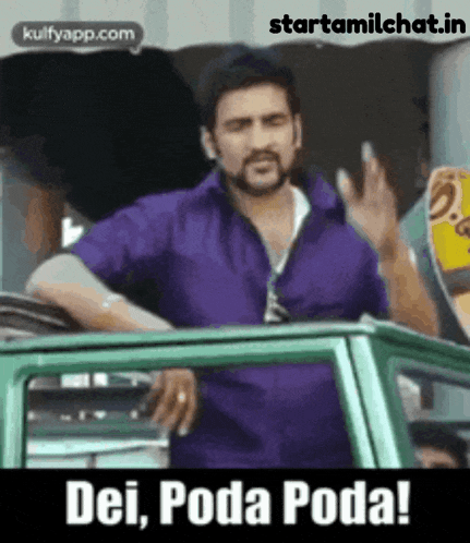 a man in a purple shirt is standing next to a green car and waving .