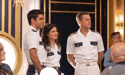 a group of people are standing next to each other in a room .