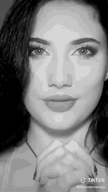 a woman 's face is shown in a black and white photo with the caption tiktok @houndervampp