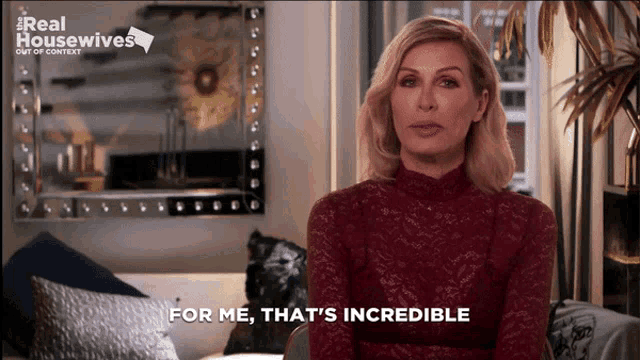 a woman says " for me that 's incredible " in front of a real housewives sign