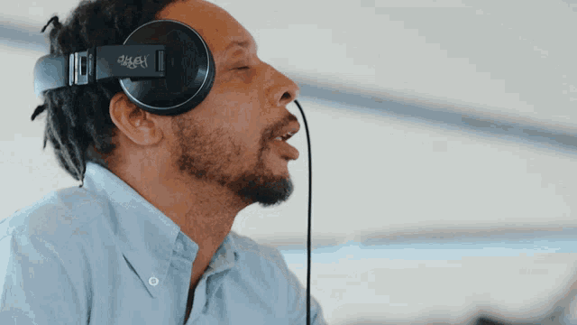 a man wearing a pair of headphones with a sticker on them that says ' a & a '