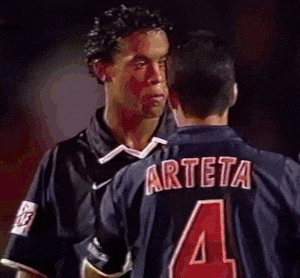 a man wearing a jersey with the number 4 on it is talking to another man