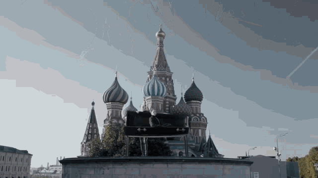 a statue of a man is sitting on top of a large building