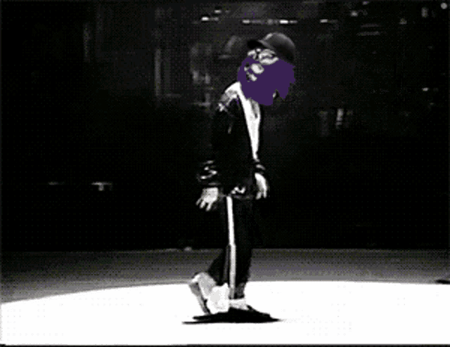 a black and white photo of a person dancing with a purple mask on their face