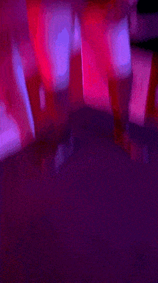 a blurry picture of a person in a red and purple room .