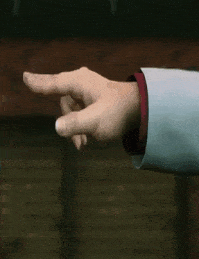 a close up of a person 's hand pointing at something .
