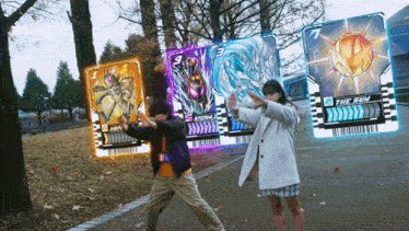 a boy and a girl are standing in front of a card that says the sun on it