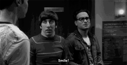 a black and white photo of three men standing next to each other with one saying smile .