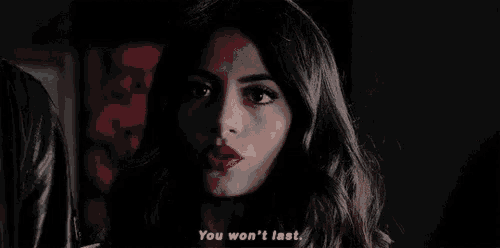 a woman is talking to a man in a dark room and says `` you won 't last . ''