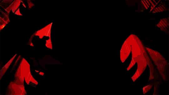 a cartoon character is surrounded by flames in a black background .