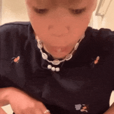 a close up of a person wearing a necklace