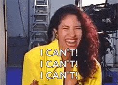 a woman in a yellow jacket is laughing and saying i can 't !