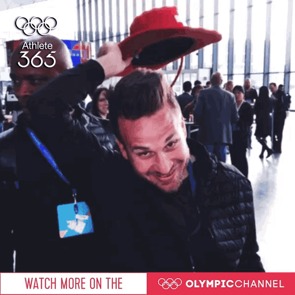 a man wearing a red hat with athlete 365 written on it