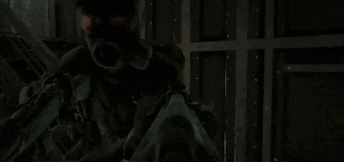 a man wearing a gas mask is standing in a dark room with stairs .