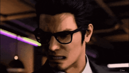 a man wearing glasses and a suit looks angry