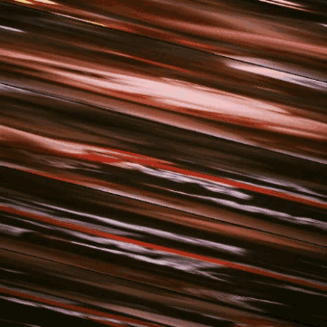 a blurred image of a metallic surface with red and white stripes
