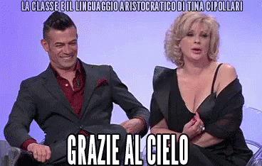 a man and a woman are sitting next to each other and the woman is wearing a bra
