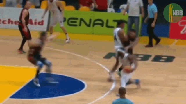 a basketball game is being played on a court with a penalty advertisement in the background