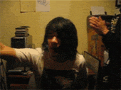a person standing in a room with their arms outstretched in front of a stack of cds