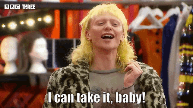 a woman with blonde hair and a leopard print coat says i can take it baby