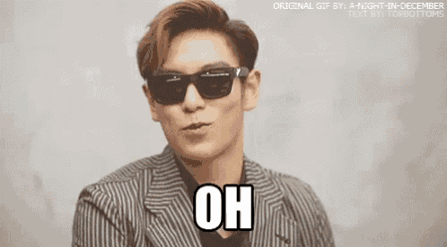 a man wearing sunglasses and a striped suit is saying oh