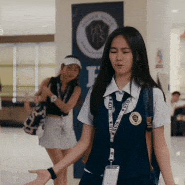 a girl with a lanyard around her neck that says ' hvts ' on it