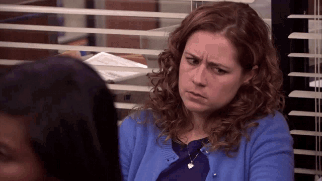 a woman in a blue sweater is looking at another woman