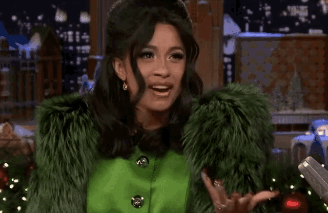 a woman in a green fur coat is making a face