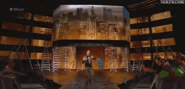 a man stands on a stage in front of a large screen that says the nextbigthing