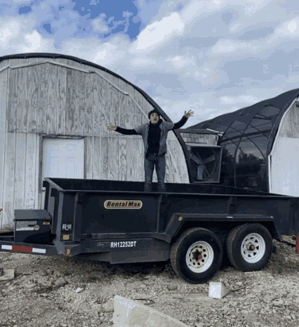 a man is standing on a rental max trailer