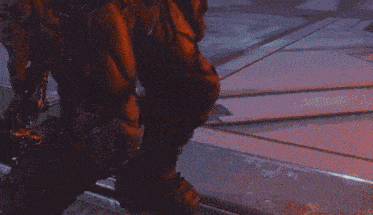 a person is holding a gun that is shooting a red light