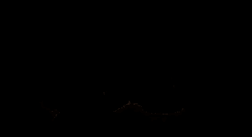 a naked man is kneeling down in a dark room with his head down .