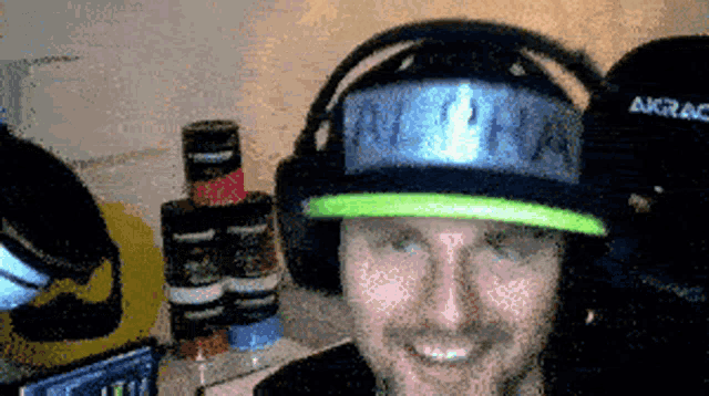 a man wearing headphones and a hat that says akrac on it