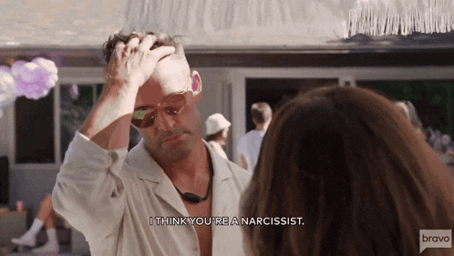 a man talking to a woman with the words " i think you 're a narcissist " on the bottom