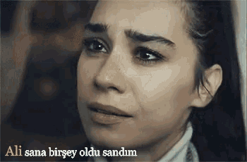 a close up of a woman 's face with a caption that says ' ali sana birsey oldu sandim ' .