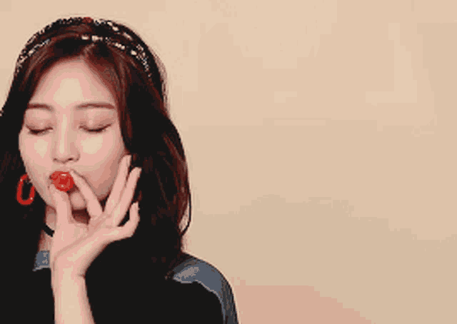 a woman with a cherry in her mouth is winking