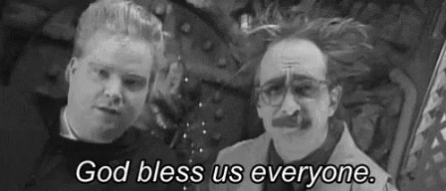 two men are standing next to each other in a black and white photo and one of them is saying `` god bless us everyone '' .