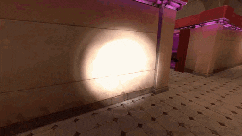 a shadow of a person is cast on a wall with the word coca cola visible