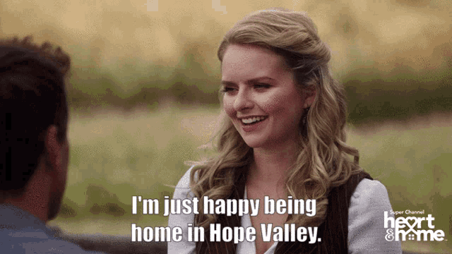 a woman is smiling and says i 'm just happy being home in hope valley ..