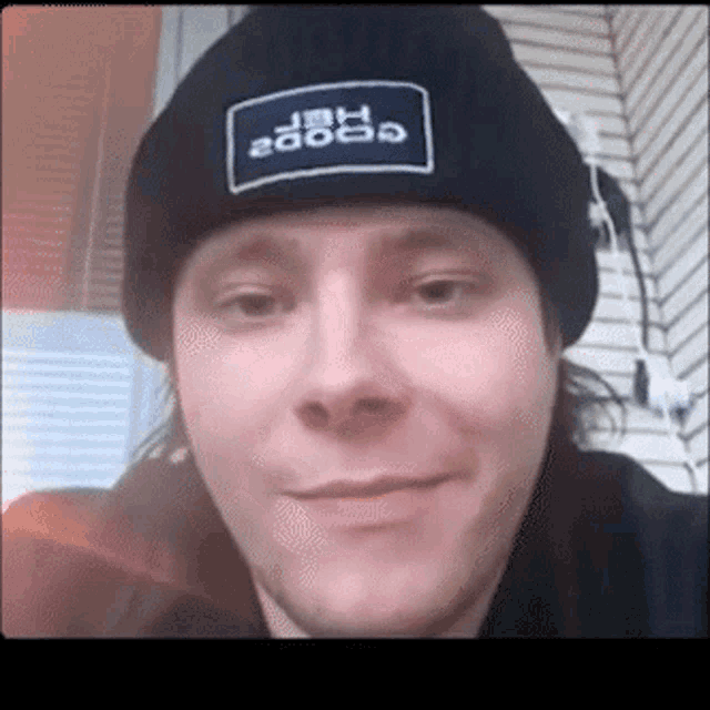 a man wearing a black beanie has a patch on it that says " jbh 2000 "