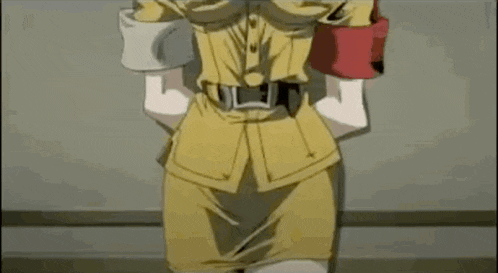 a woman in a yellow uniform with a red armband is standing with her hands in her pockets .