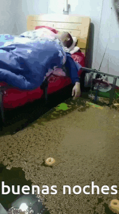 a person is laying on a bed in a flooded room with the words buenas noches written on the bottom