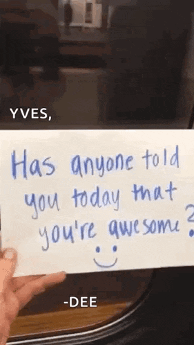 a person is holding a piece of paper that says `` has anyone told you today that you 're awesome '' .