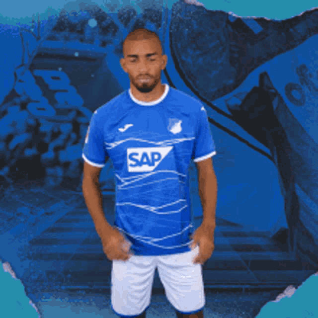 a man wearing a blue shirt with sap on it