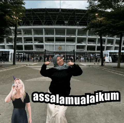 a woman stands in front of a stadium with the words assalamualaikum written on the ground
