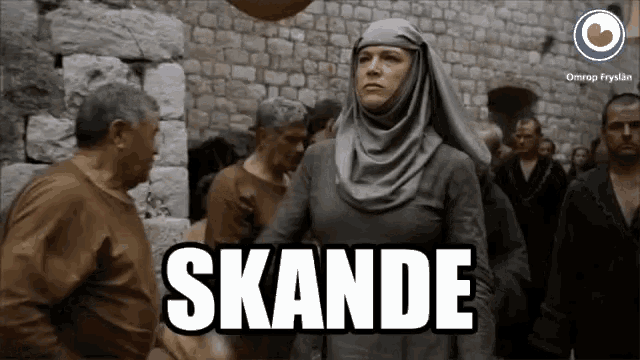 a woman in a hijab stands in front of a crowd and says " skande " in white letters