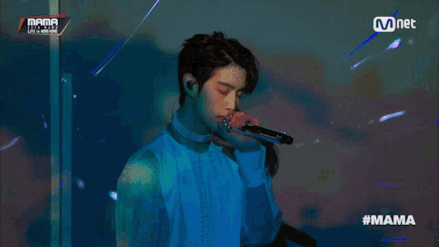 a man singing into a microphone with the hashtag mama on the bottom