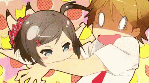 a boy is holding a girl in his arms and the girl is making a funny face