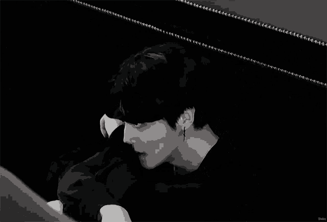 a black and white photo of a man hugging another man