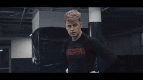 a young man wearing a black shirt that says extreme hobby fighter